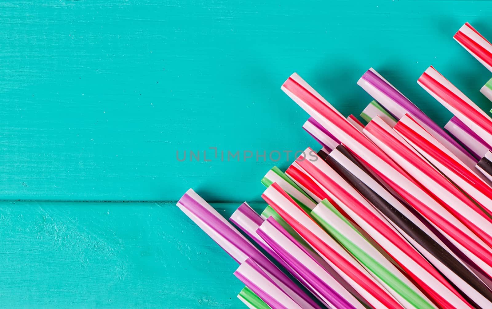 Drinking straws for party on blue pastel background with copy space. Top view