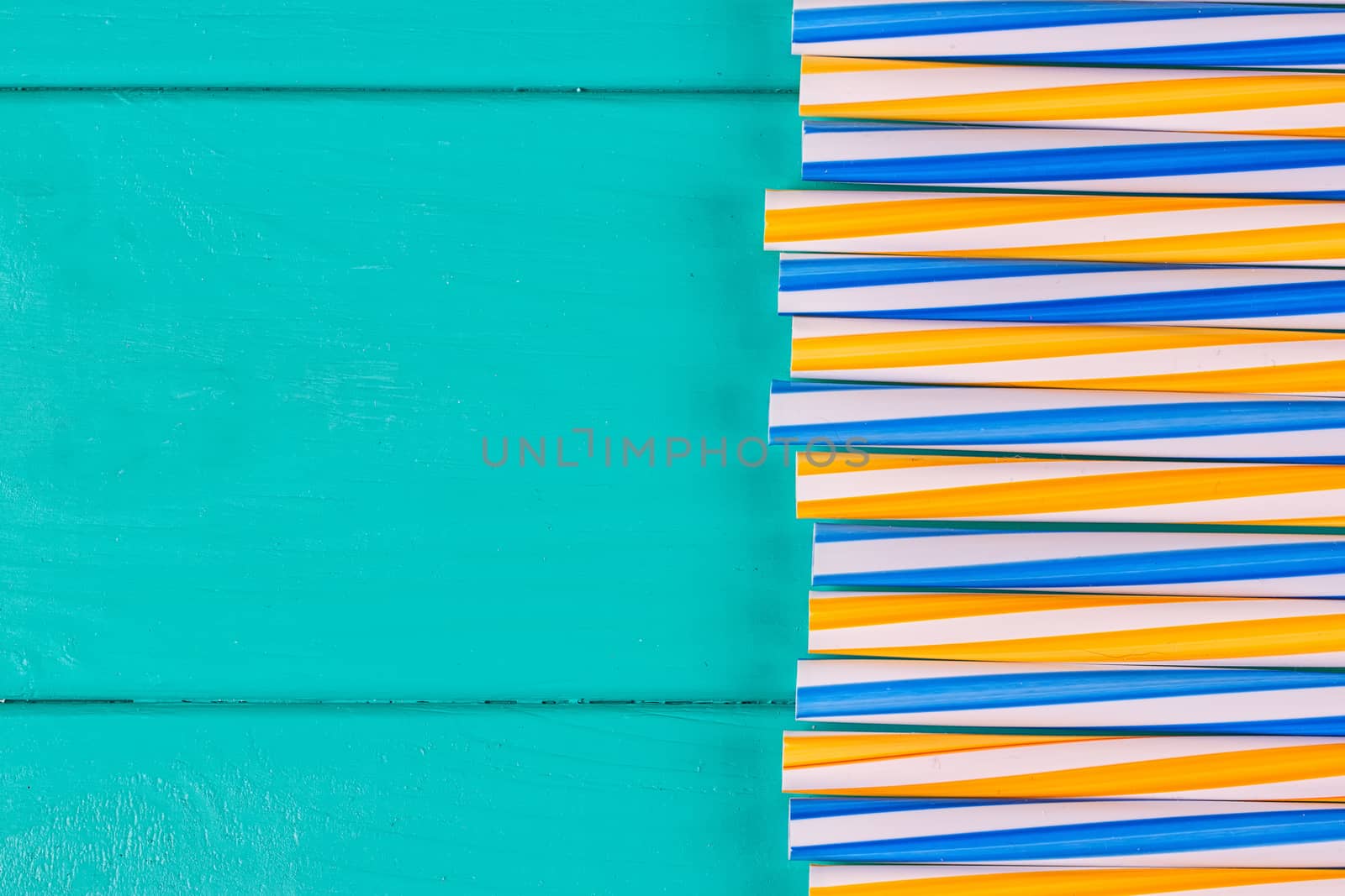 Drinking straws for party on blue pastel background with copy space. Top view