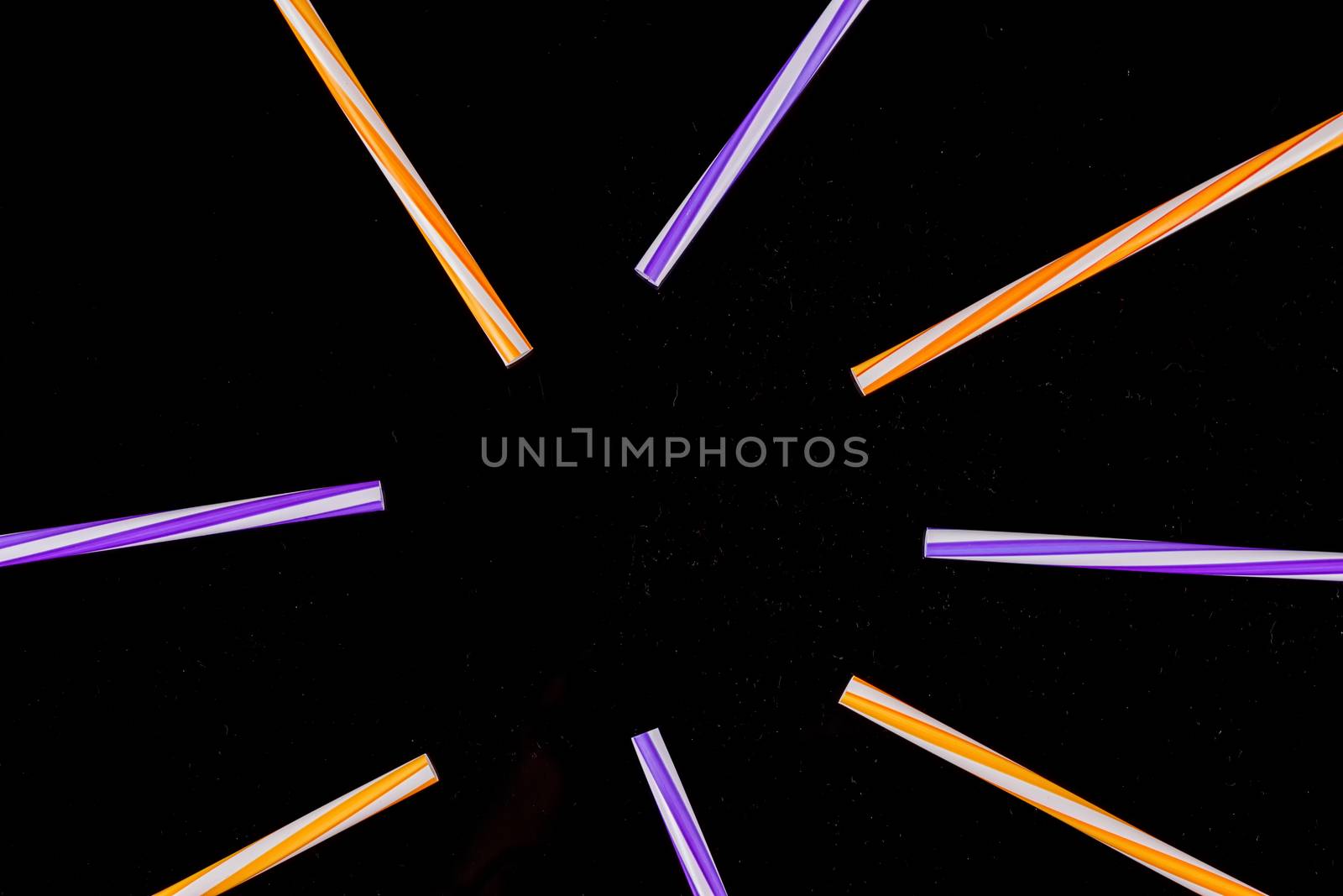 cocktail colorful plastic tube on a black background