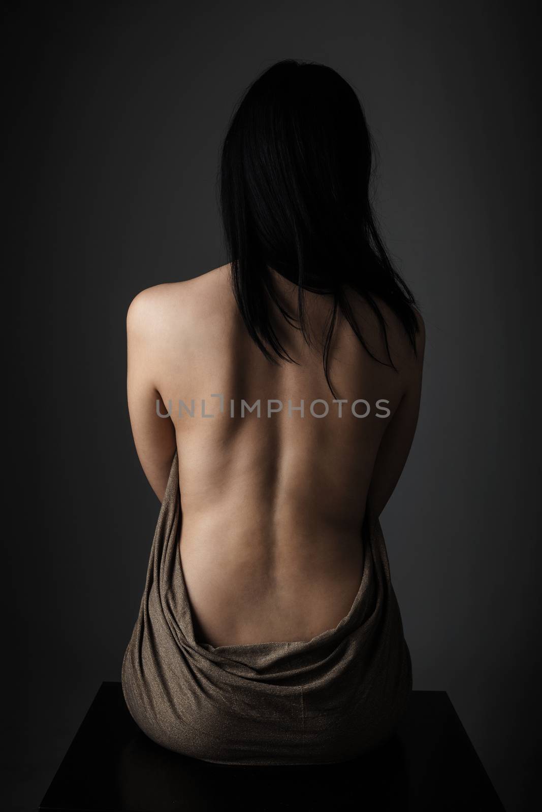 sensual portrait of black haired girl's naked back