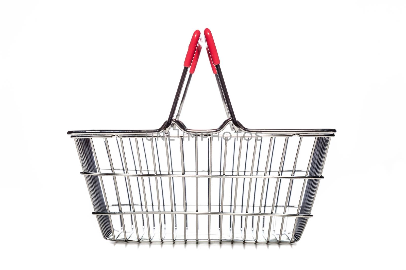 tiny metal shopping basket against white background