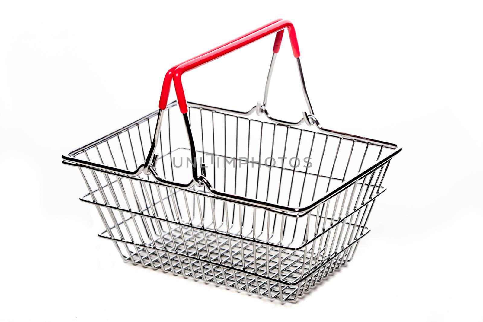 tiny metal shopping basket against white background