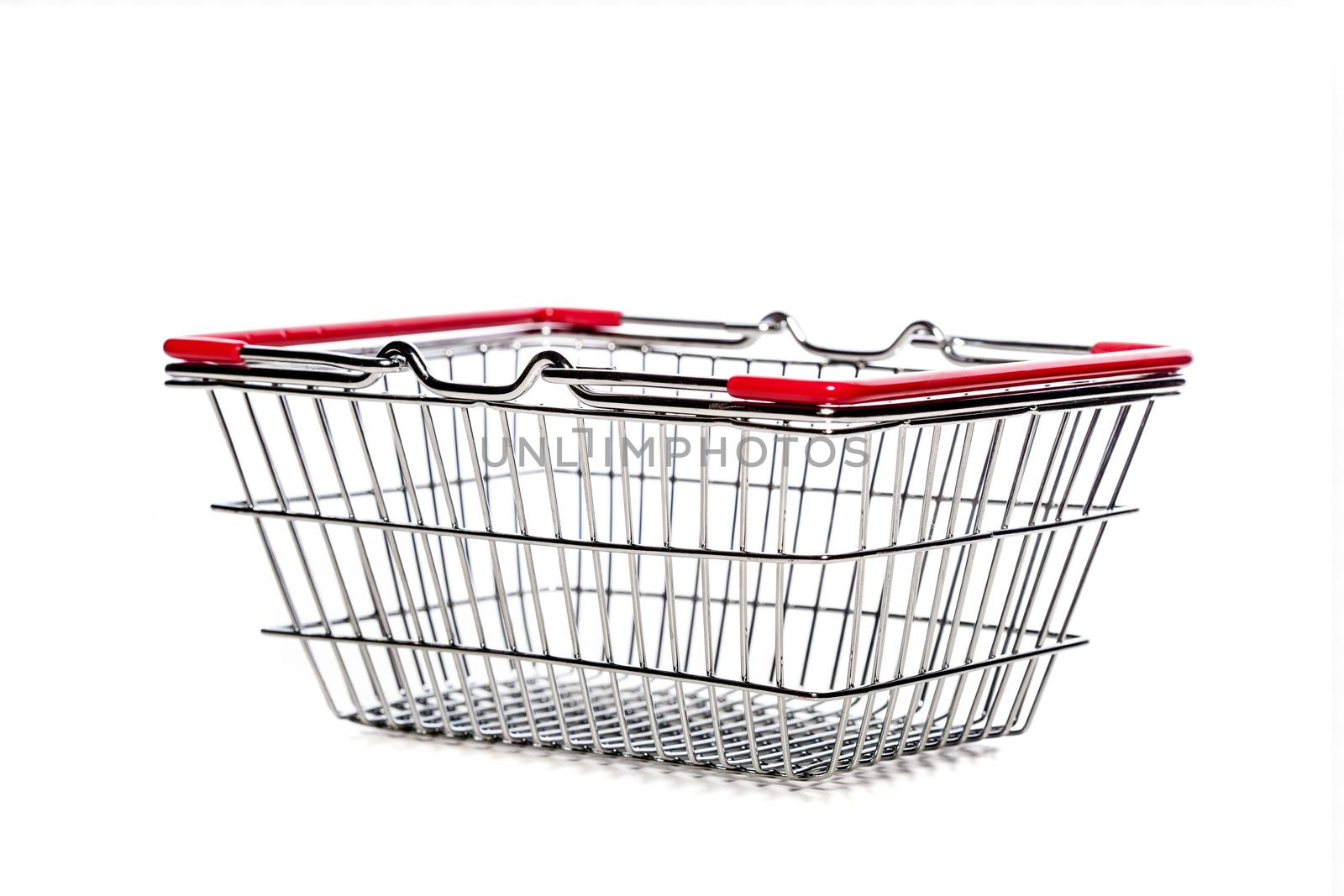 tiny metal shopping basket against white background