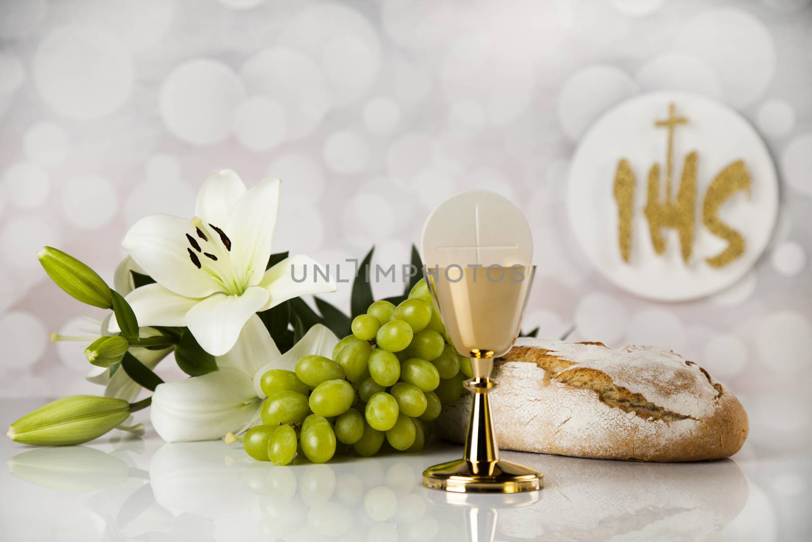 Holy communion a golden chalice with grapes and bread wafers