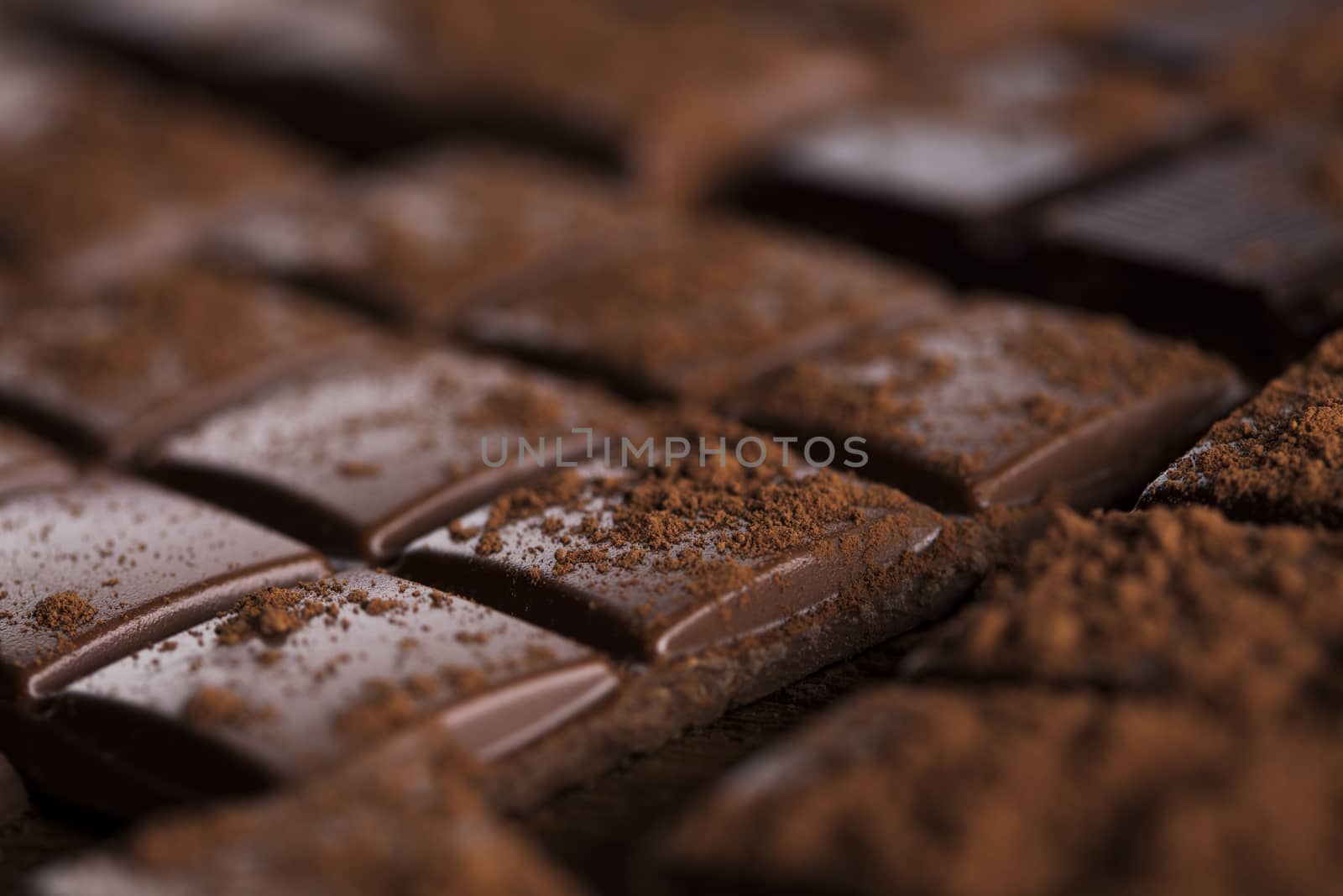 Aromatic cocoa and chocolate on wooden background