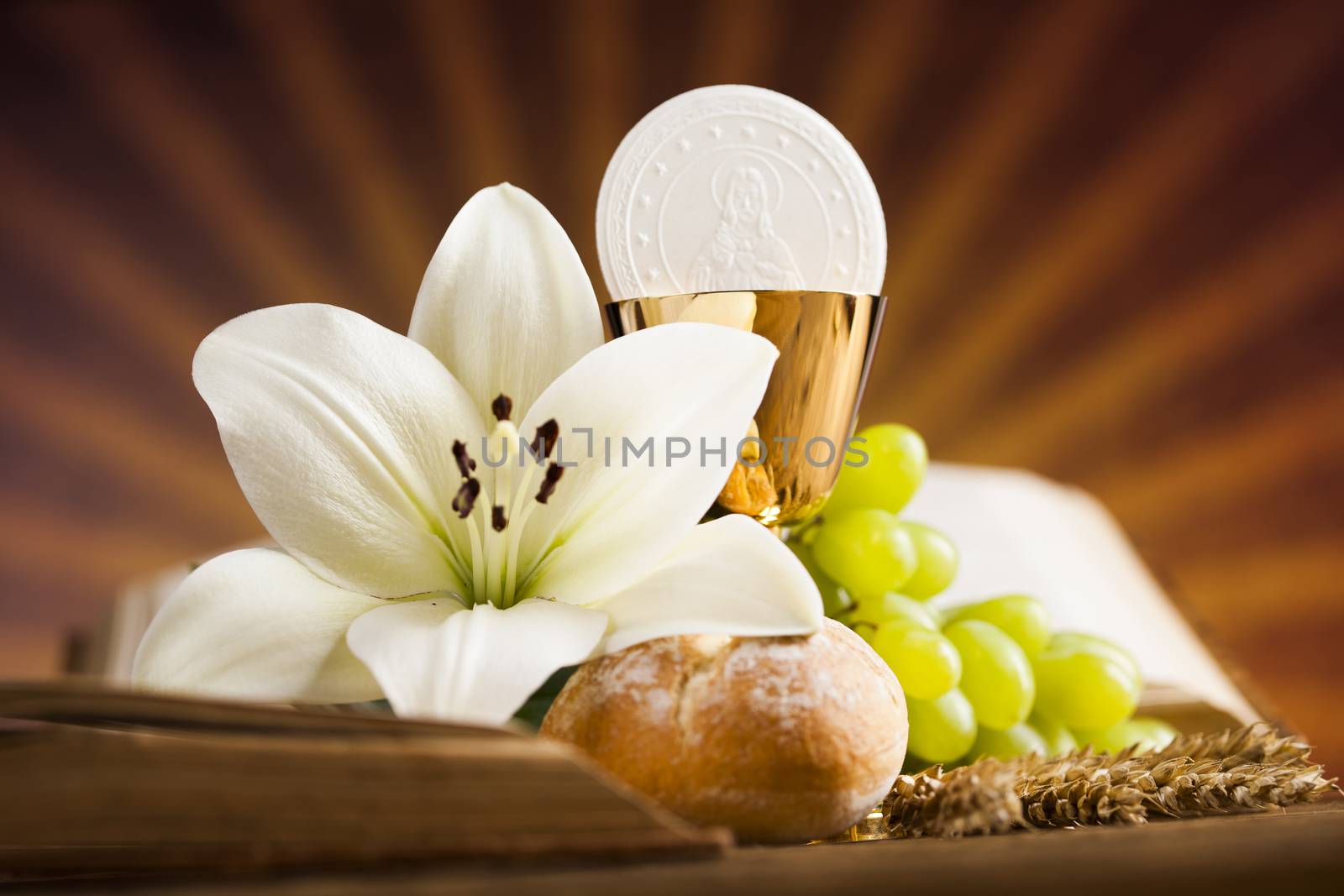 Holy communion a golden chalice with grapes and bread wafers