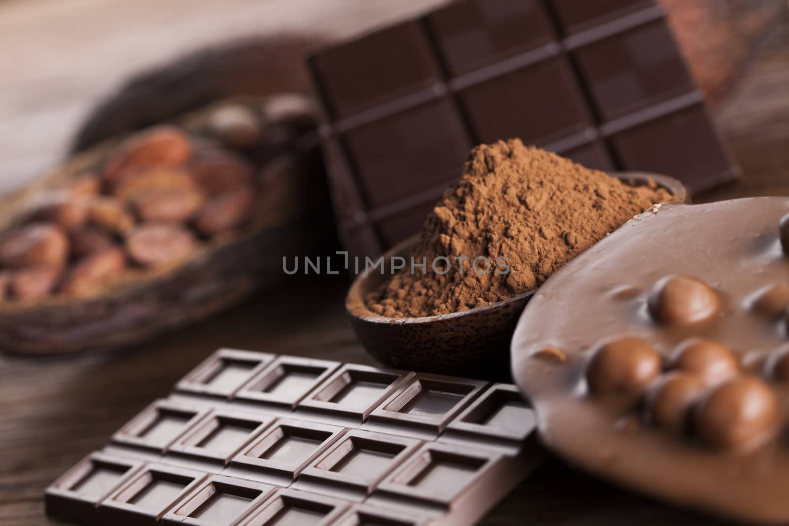 Aromatic cocoa and chocolate on wooden background