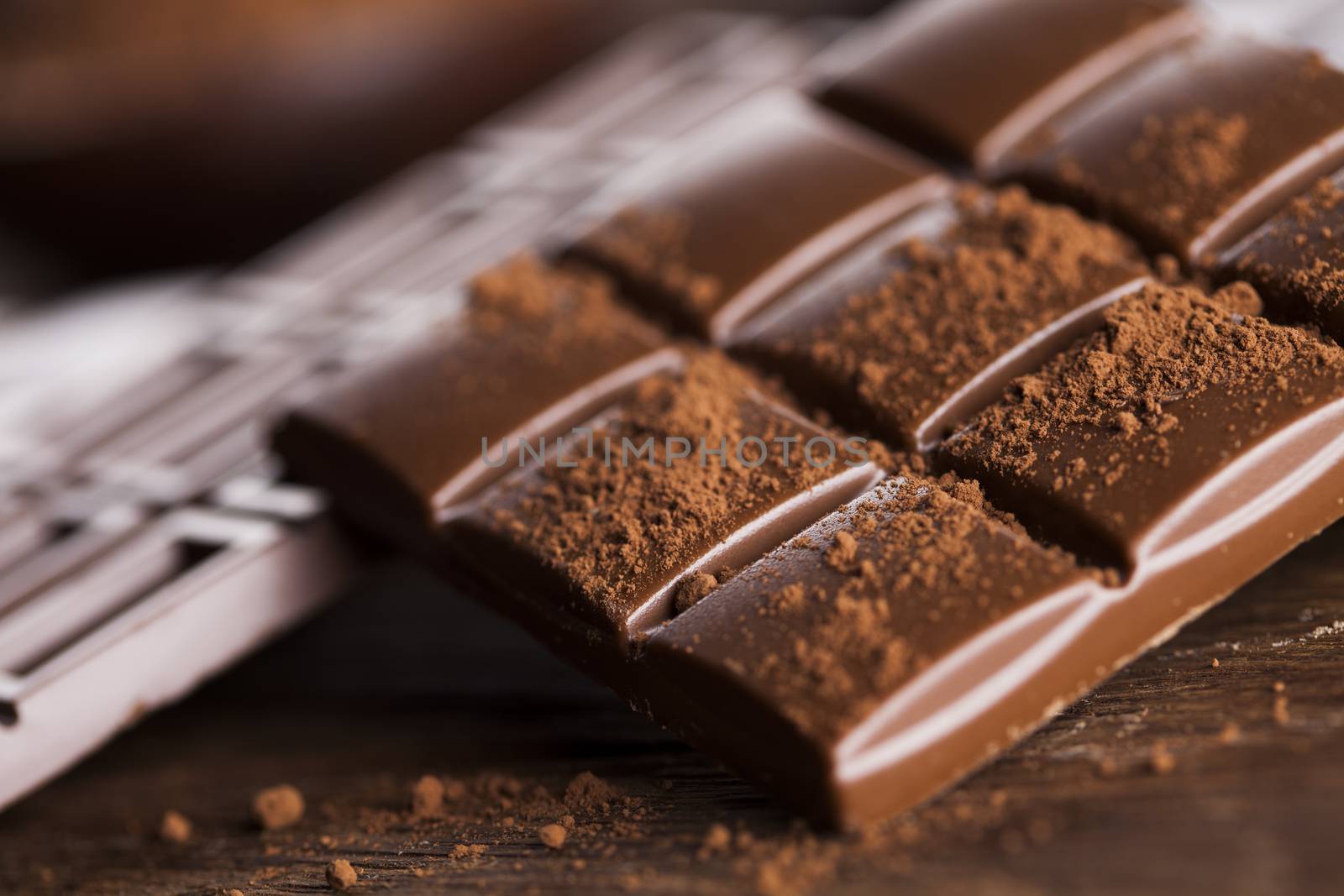 Dark homemade chocolate bars and cocoa pod on wooden  by JanPietruszka