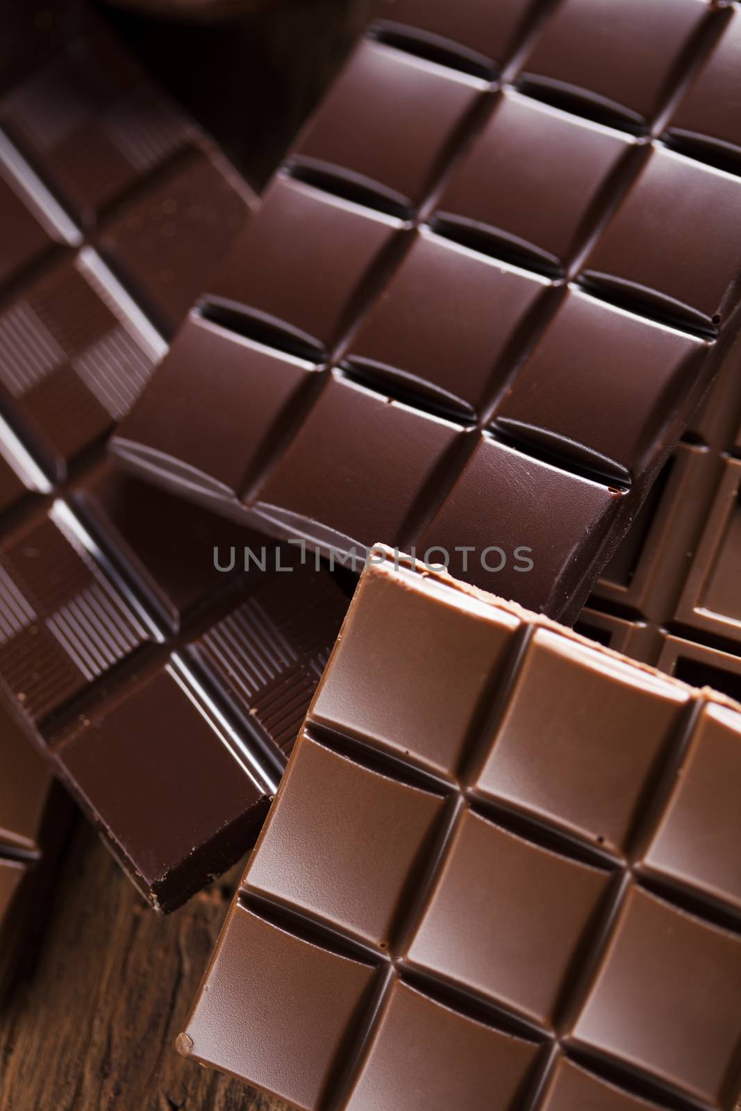 Milk and dark chocolate on a wooden table