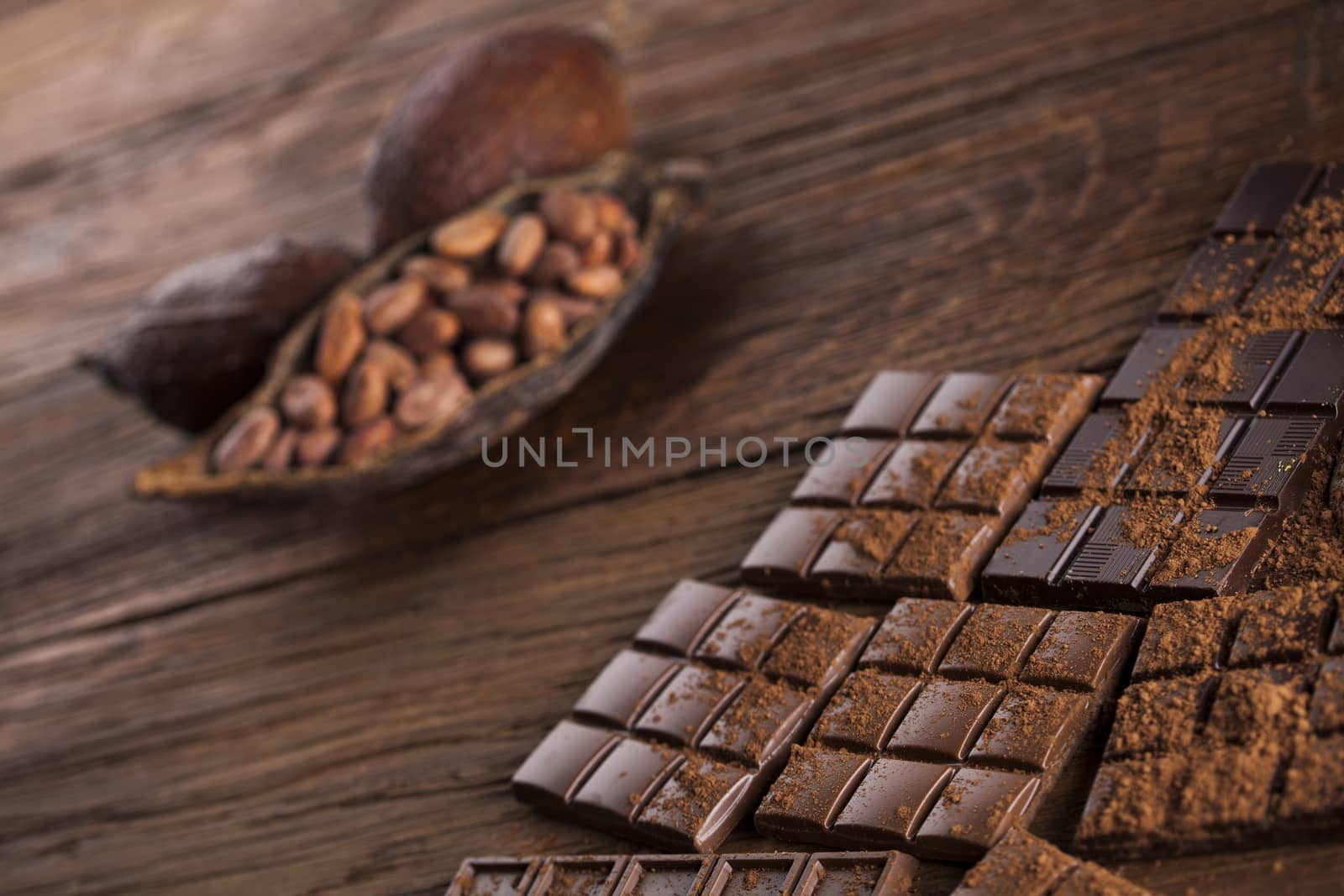 Aromatic cocoa and chocolate on wooden background