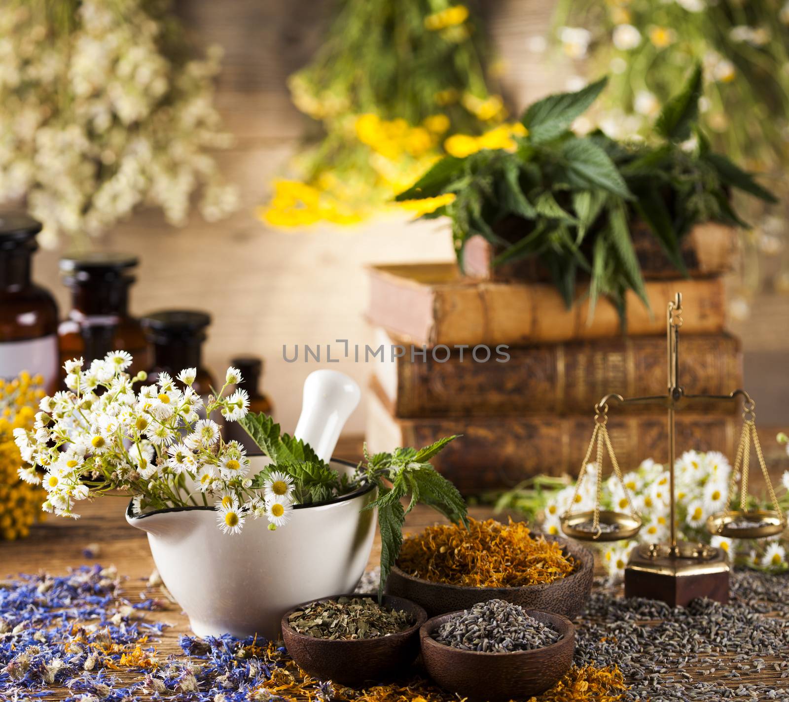 Herbs, berries and flowers with mortar, on wooden table backgrou by JanPietruszka