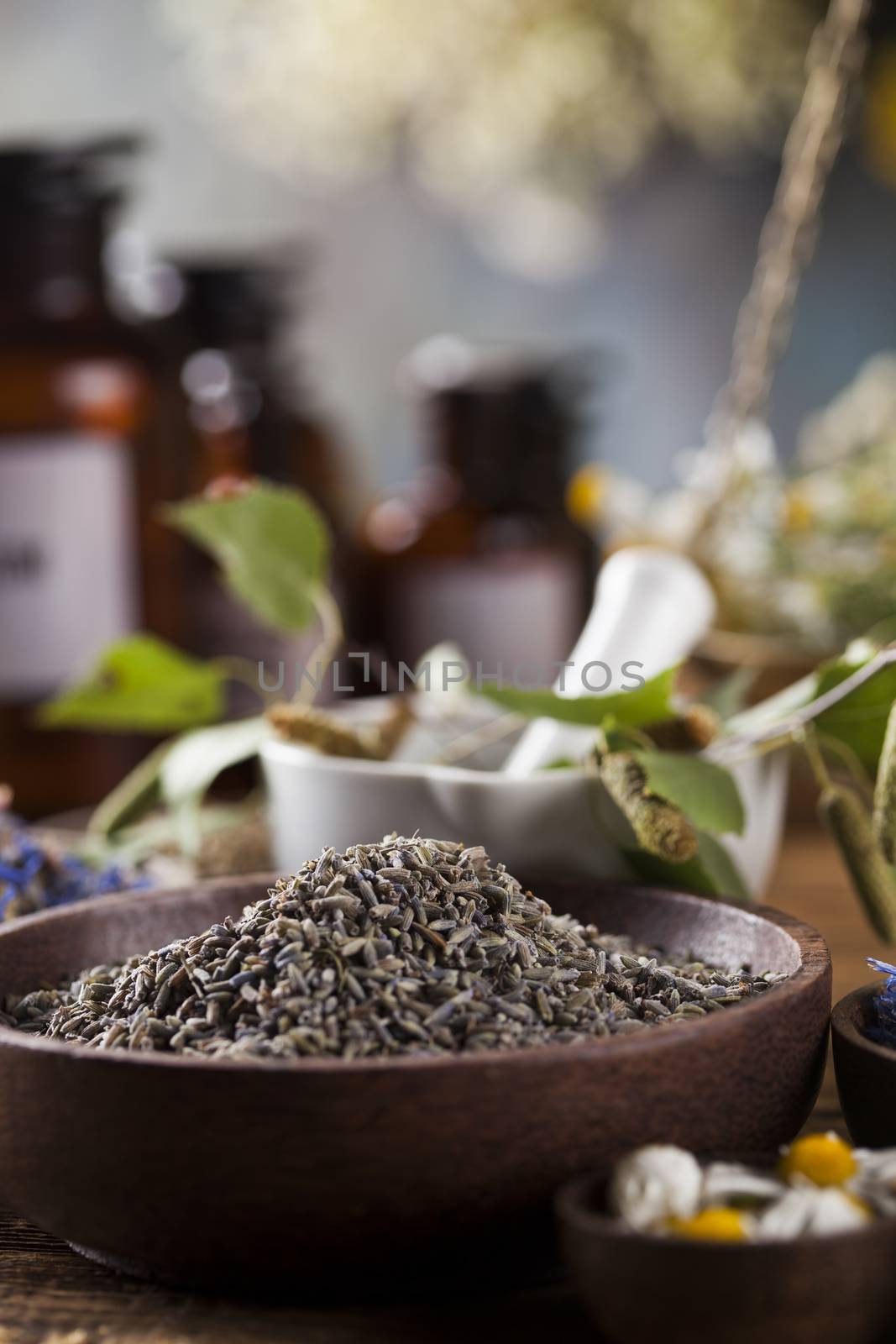 Herbs medicine,Natural remedy and mortar on vintage wooden desk  by JanPietruszka