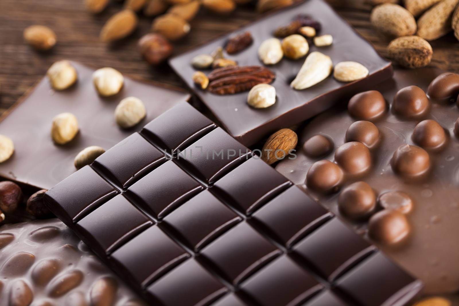 Dark homemade chocolate bars and cocoa pod on wooden  by JanPietruszka