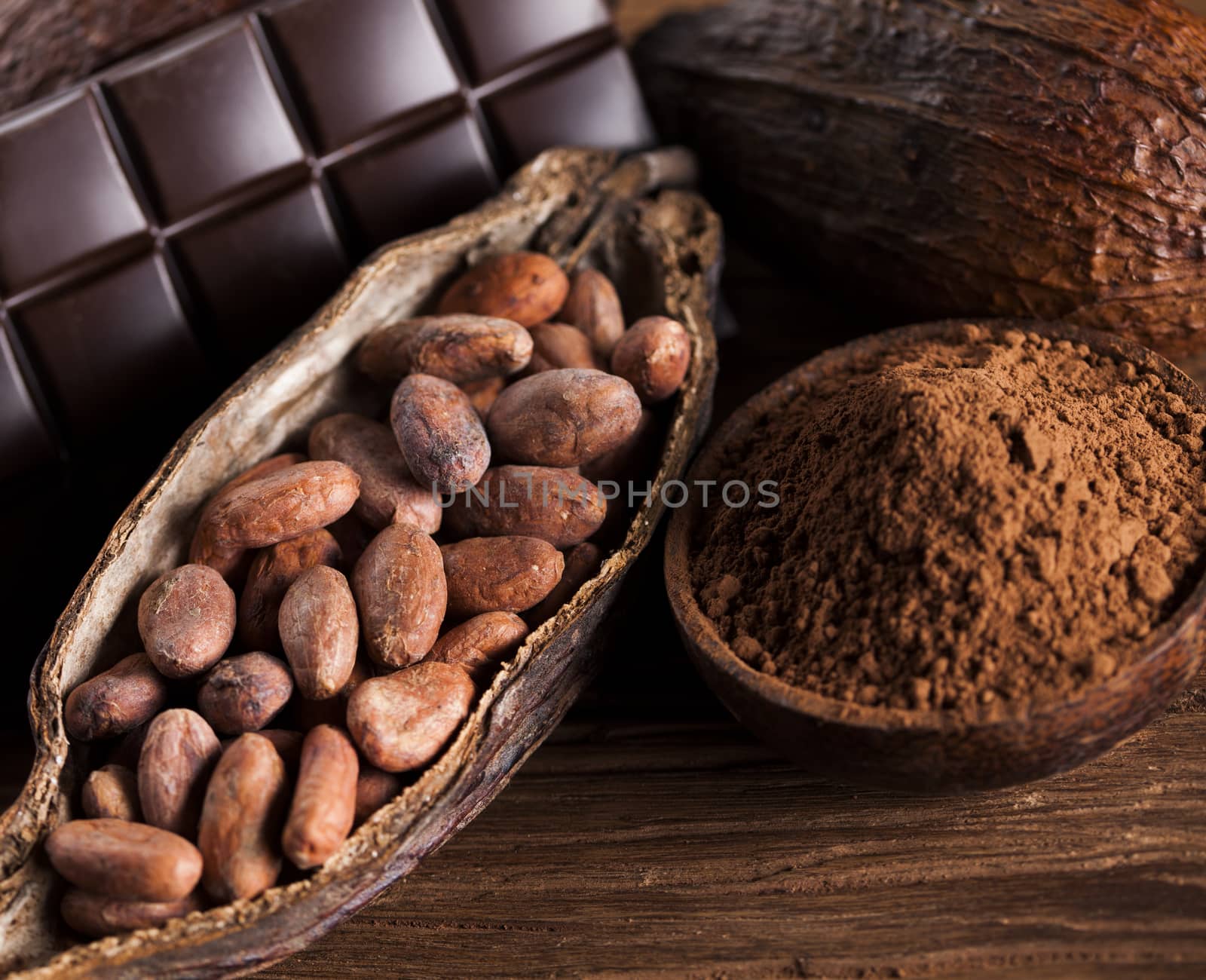 Cocoa pod and cocoa beans on the wooden table by JanPietruszka