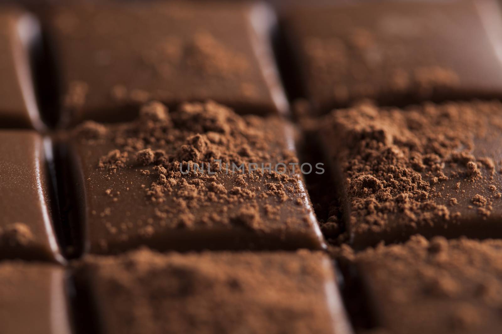 Dark and milk chocolate bar on a wooden table  by JanPietruszka