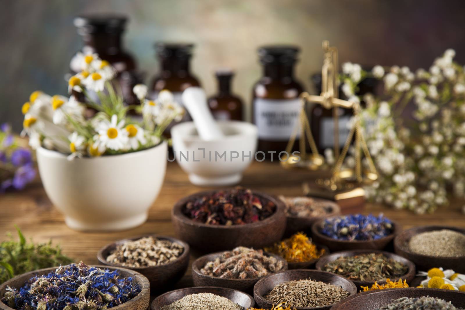 Alternative medicine, dried herbs and mortar on wooden desk back by JanPietruszka