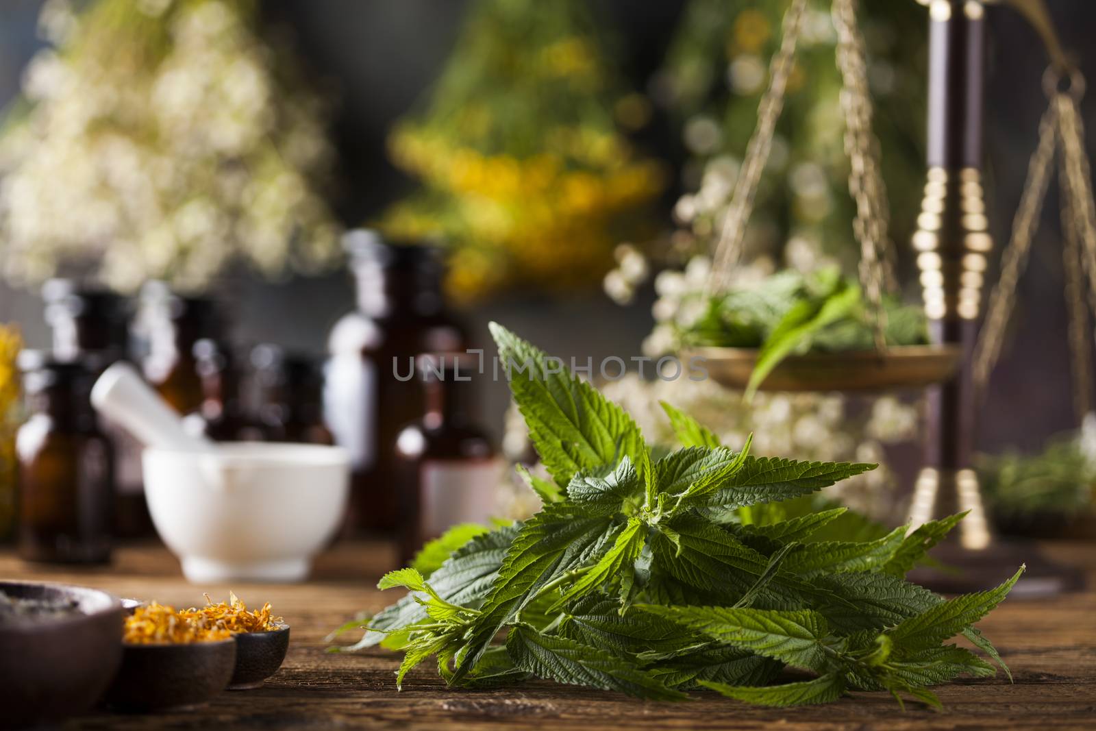 Herbs medicine,Natural remedy and mortar on vintage wooden desk  by JanPietruszka