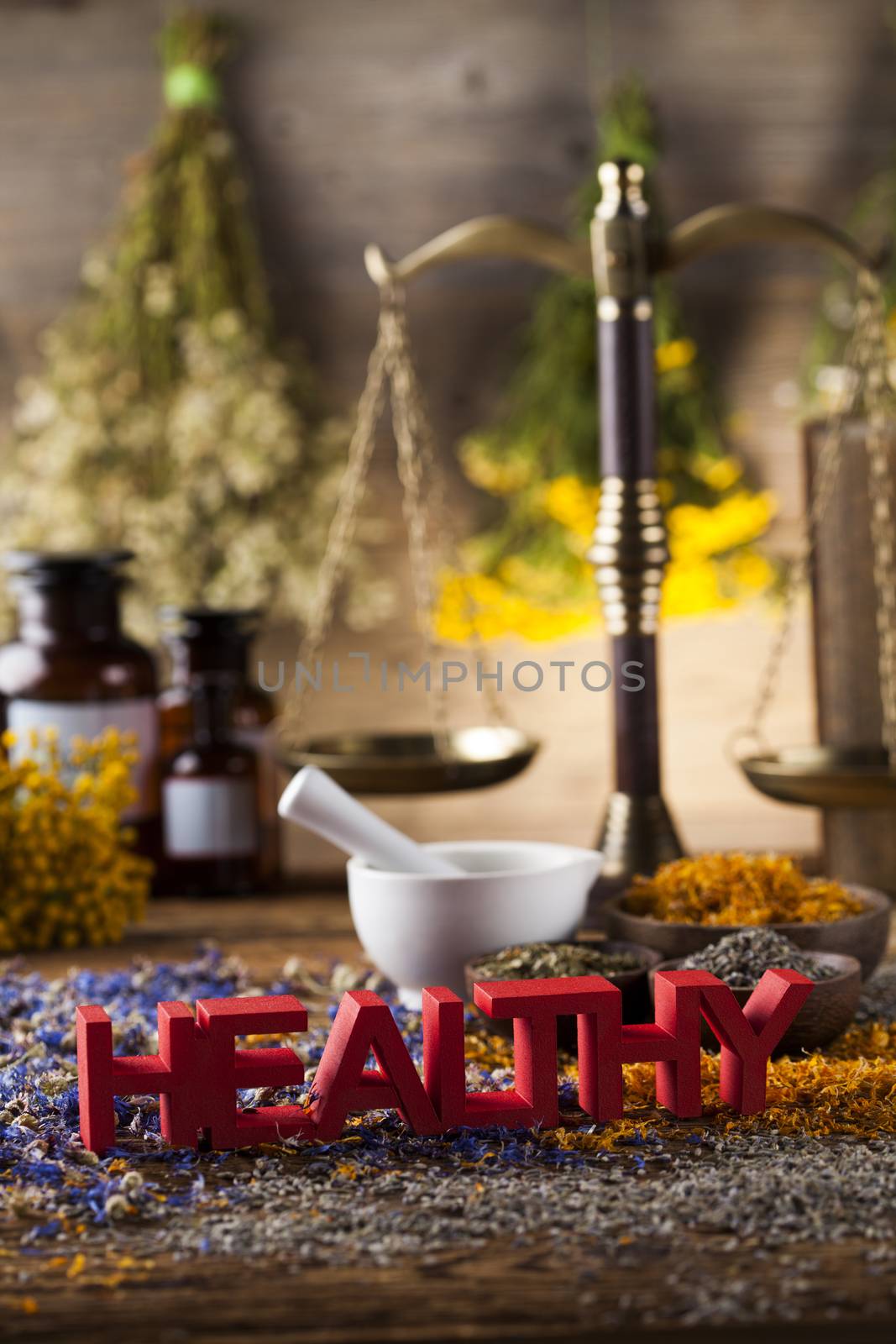 Healthy herbs on wooden table, mortar and herbal medicine  by JanPietruszka