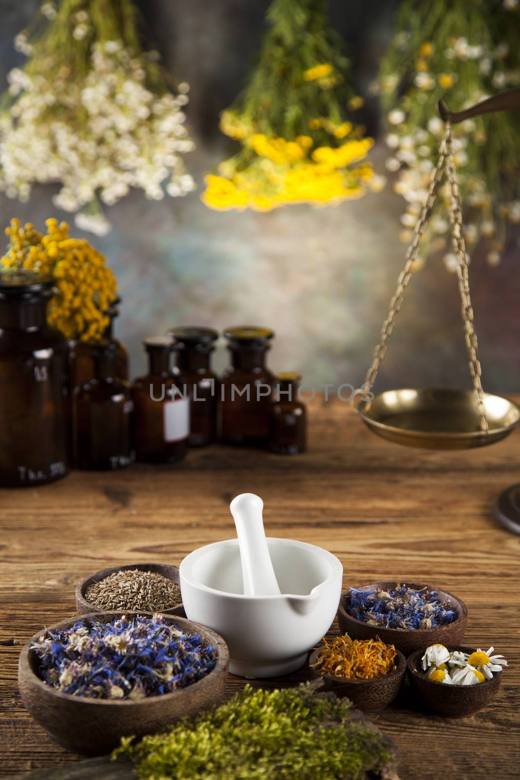 Natural medicine, herbs, mortar on wooden table background