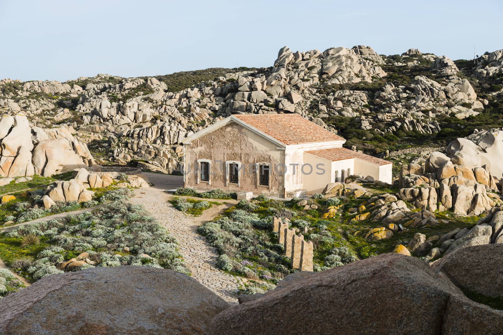 old abandonned house at capo testa teresa di gallura , with rocks and blue sea on the italian island of sardinia
