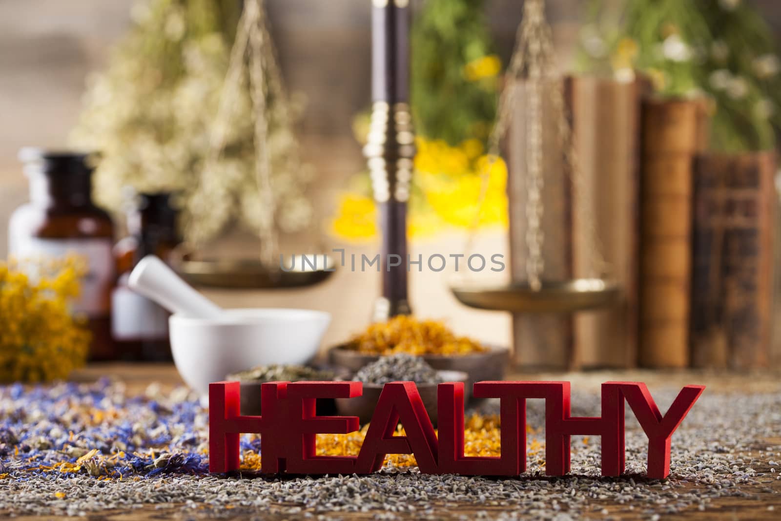 Healthy herbs on wooden table, mortar and herbal medicine  by JanPietruszka