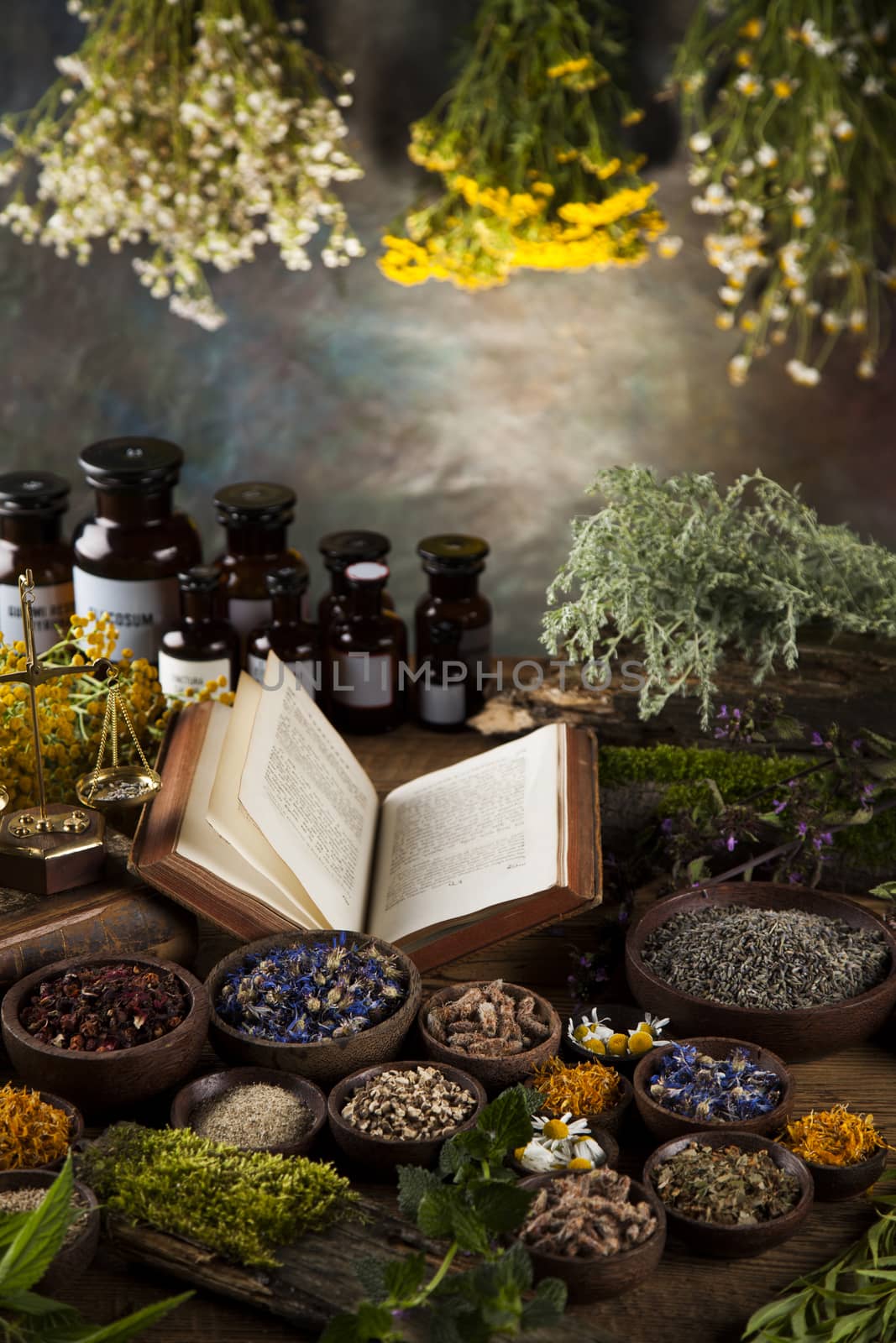 Book and Herbal medicine on wooden table background by JanPietruszka