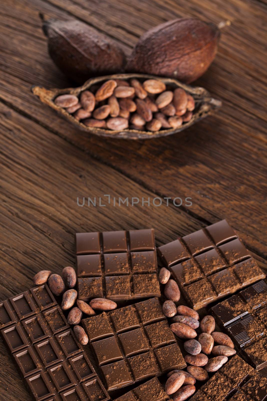 Milk and dark chocolate on a wooden table