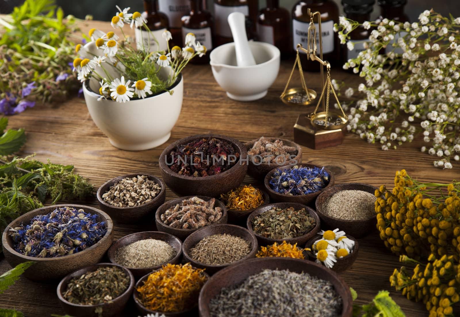 Healing herbs on wooden table, mortar and herbal medicine