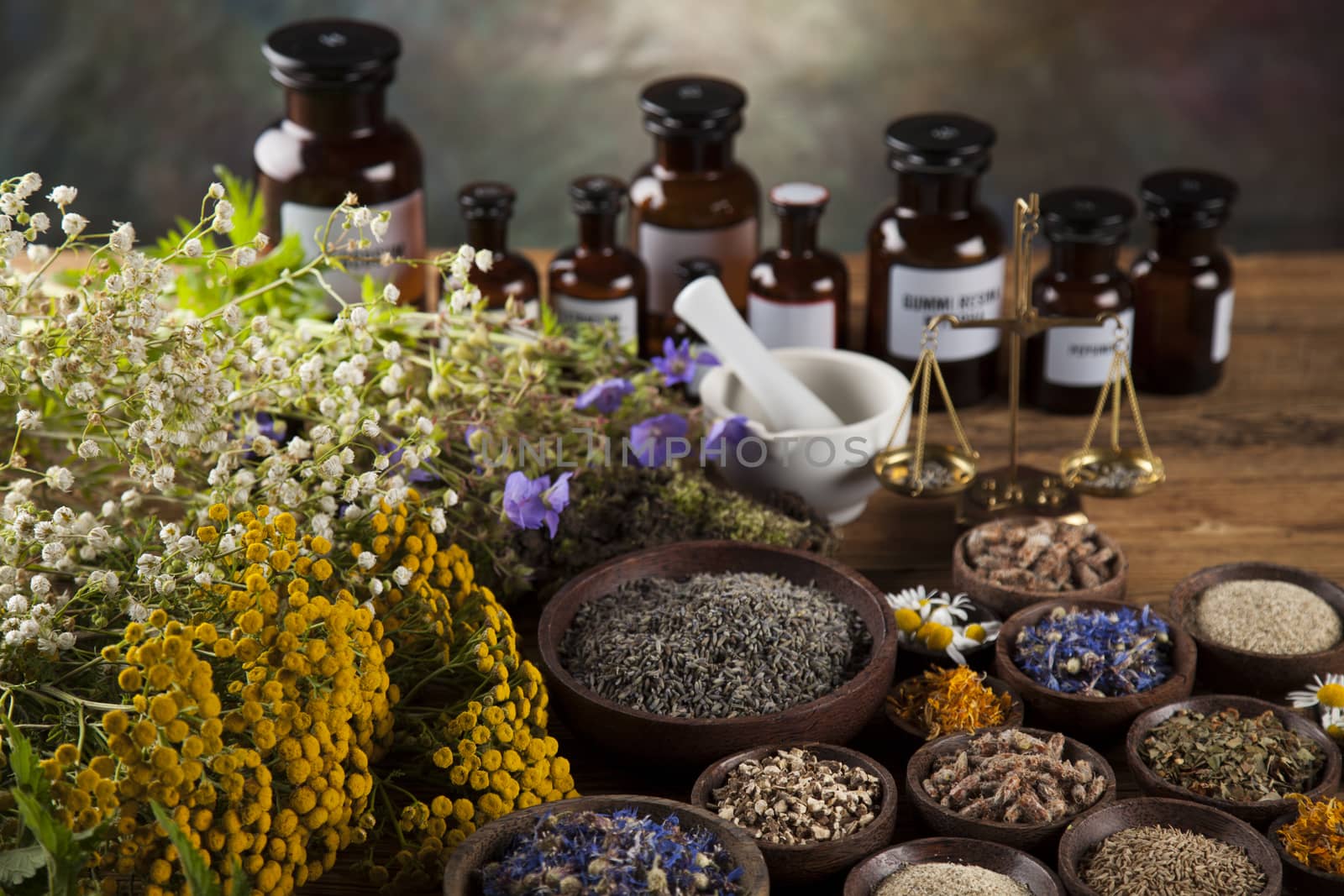 Herbs, berries and flowers with mortar, on wooden table backgrou by JanPietruszka