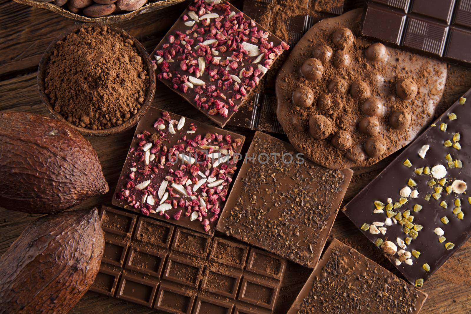 Dark and milk chocolate bar on a wooden table  by JanPietruszka