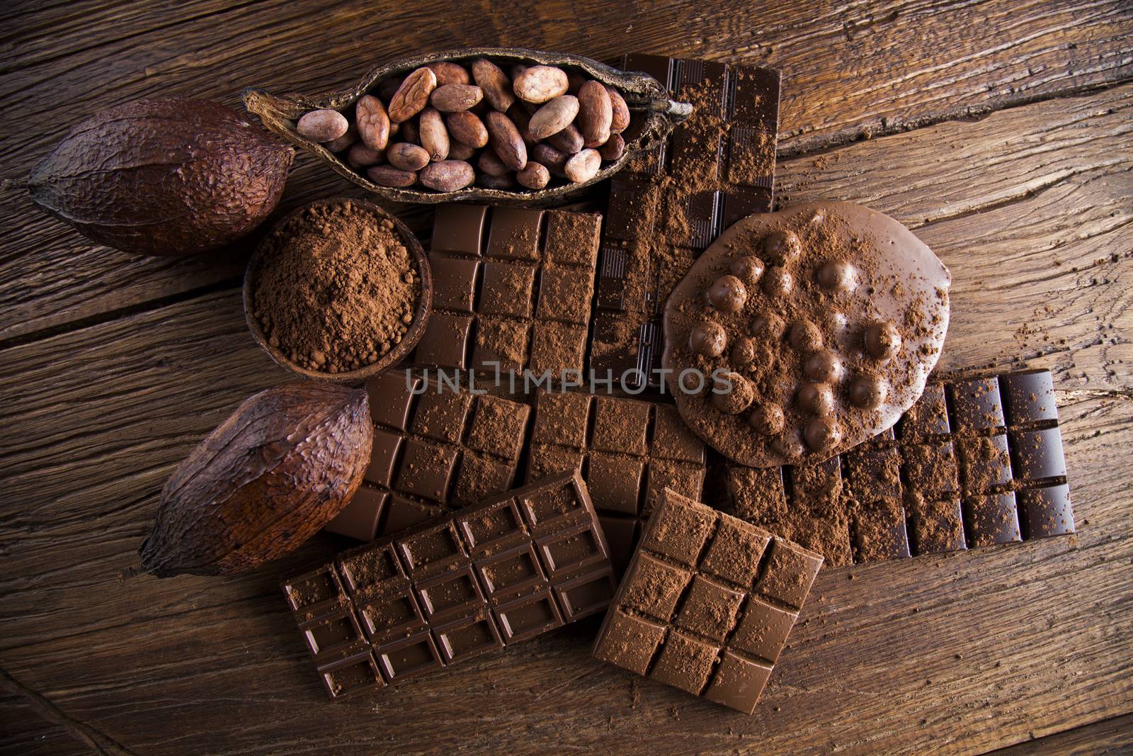 Dark and milk chocolate bar on a wooden table  by JanPietruszka