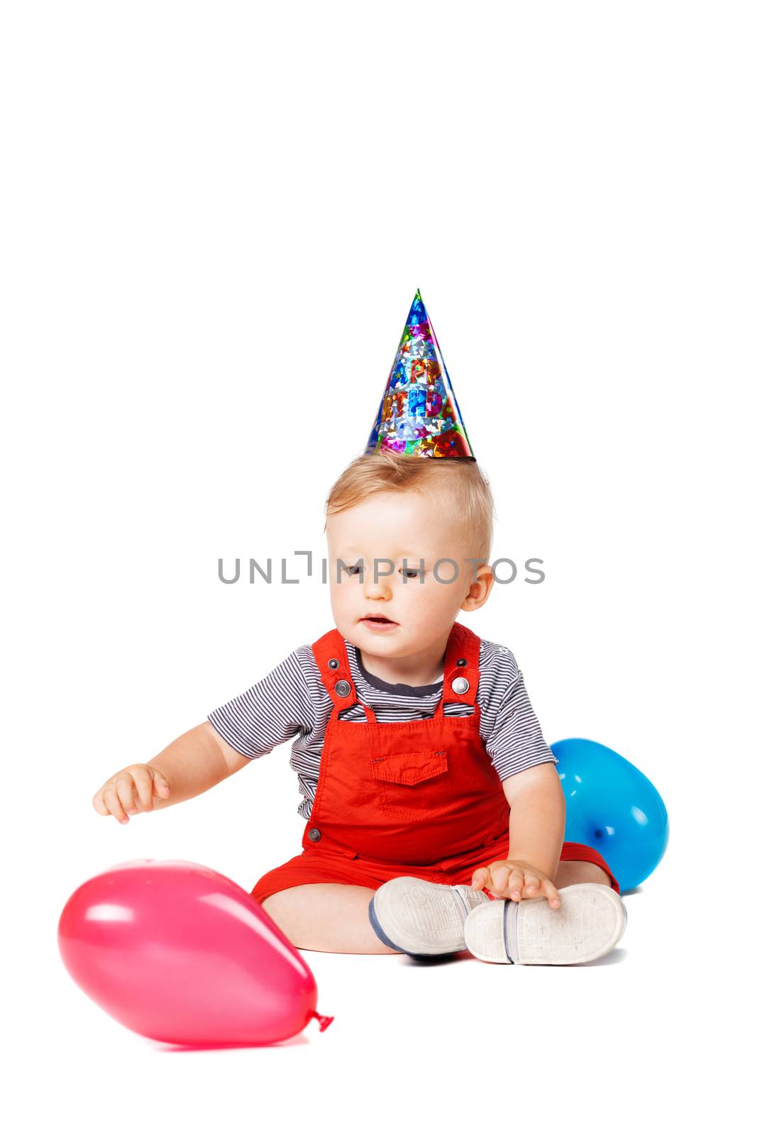 baby boy with birthday hat and balloons
