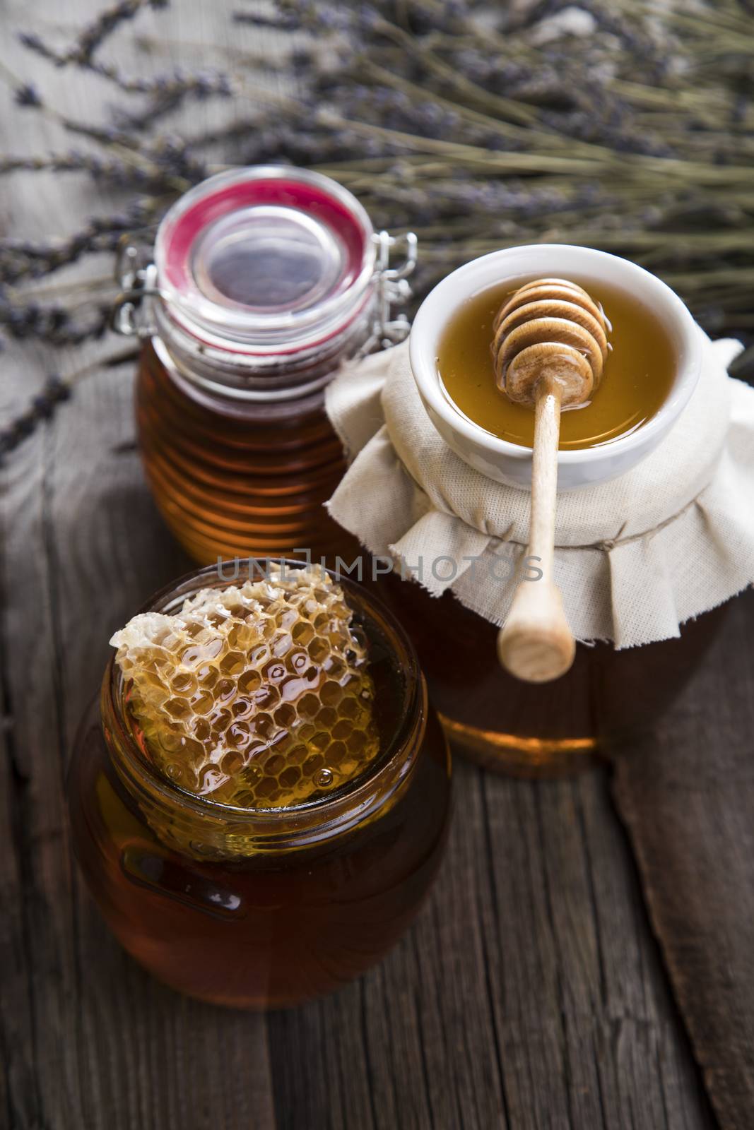 Jar of honey with honeycomb