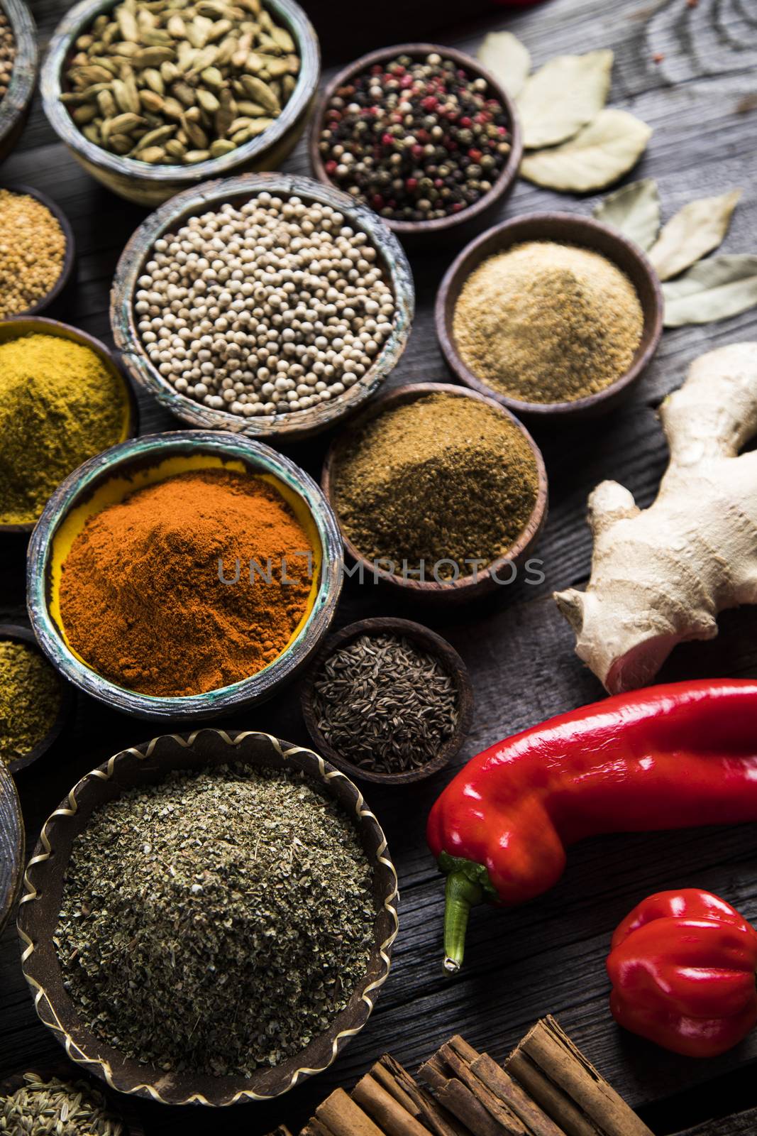 Spices on wooden bowl background  by JanPietruszka