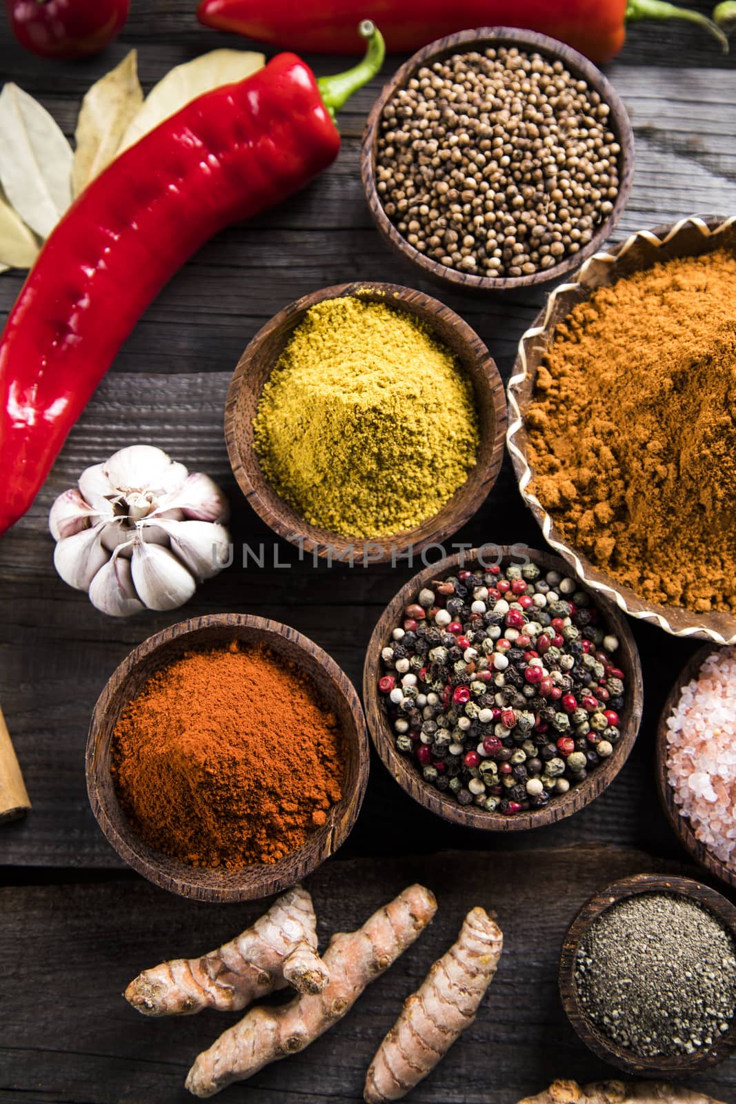 Spices and herbs in wooden bowls. Food and cuisine ingredients