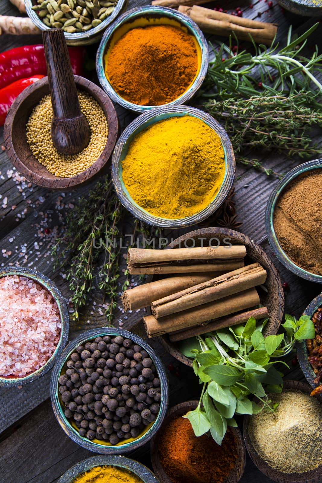 Spices and herbs in wooden bowls. Food and cuisine ingredients