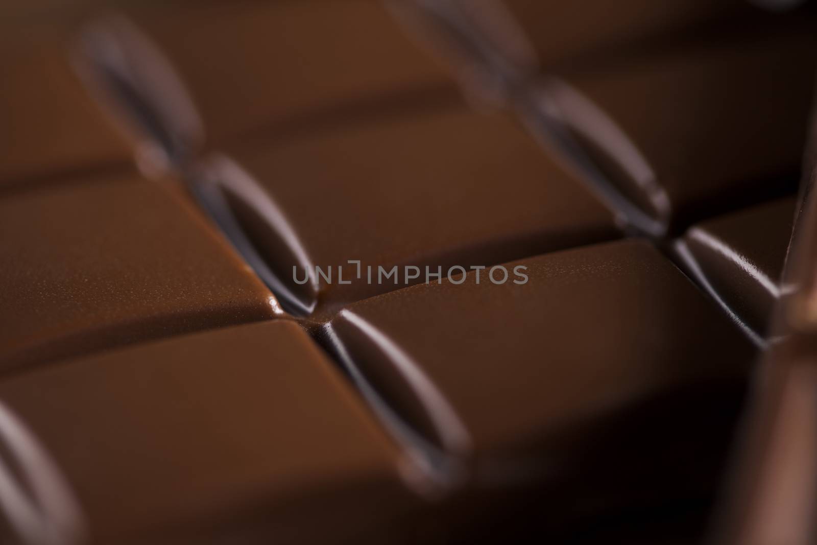 Dark and milk chocolate bar on a wooden table  by JanPietruszka