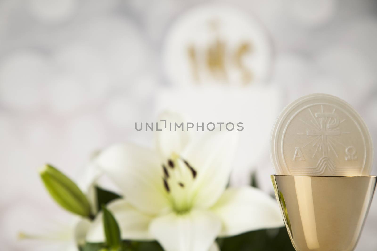 Holy communion a golden chalice with grapes and bread wafers