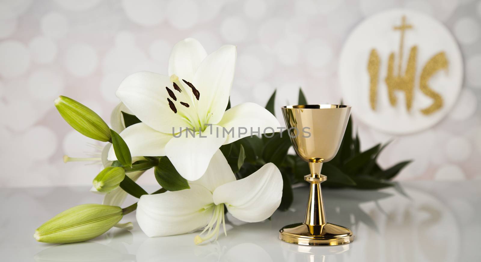 Holy communion a golden chalice with grapes and bread wafers