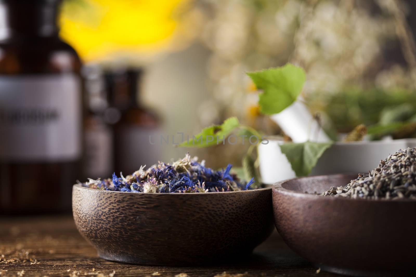 Natural medicine, herbs, mortar on wooden table background