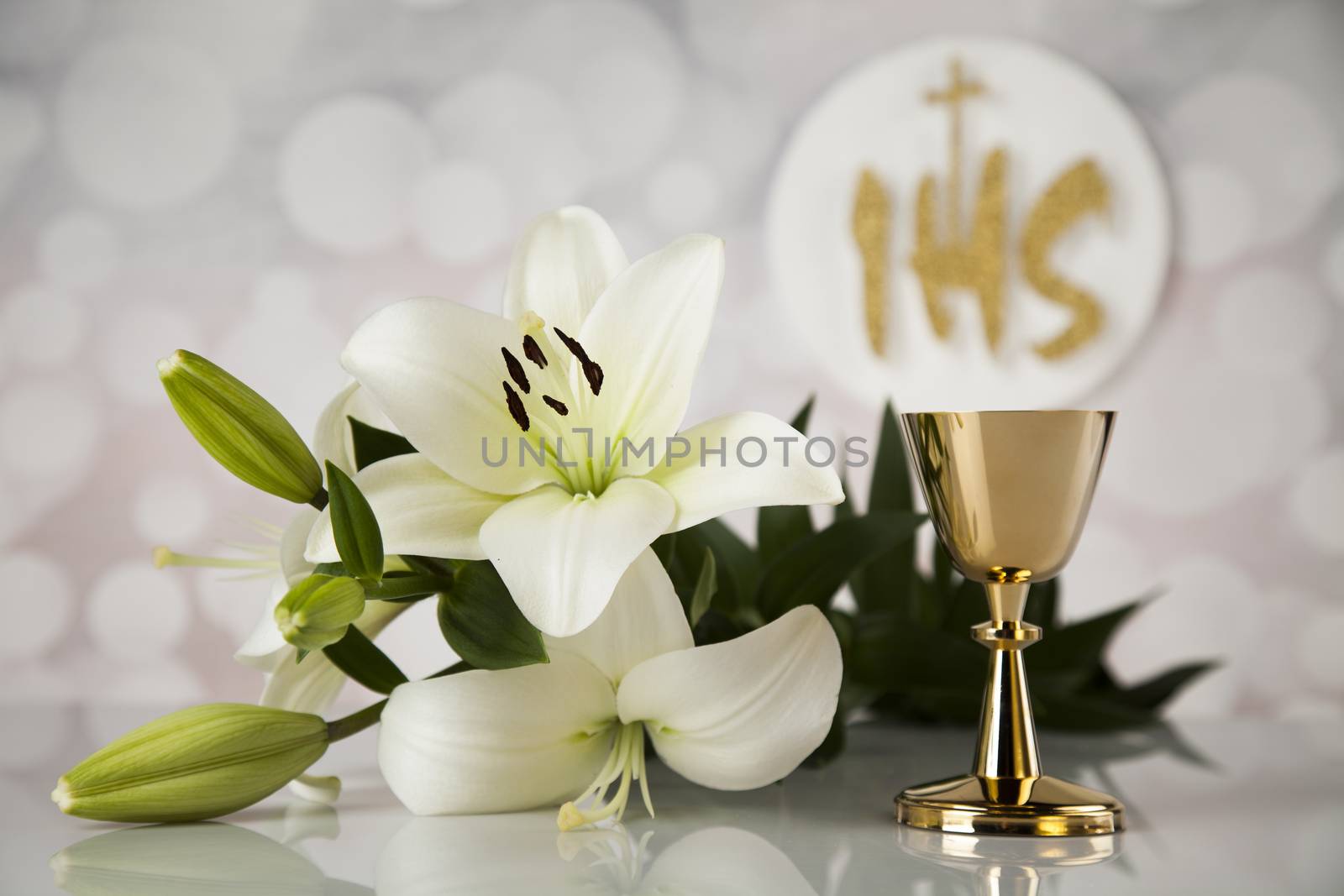 Holy communion a golden chalice with grapes and bread wafers