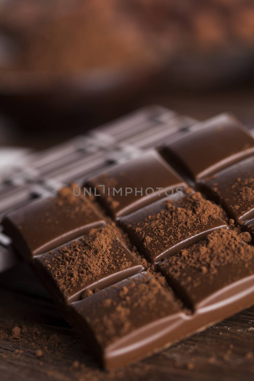 Aromatic cocoa and chocolate on wooden background