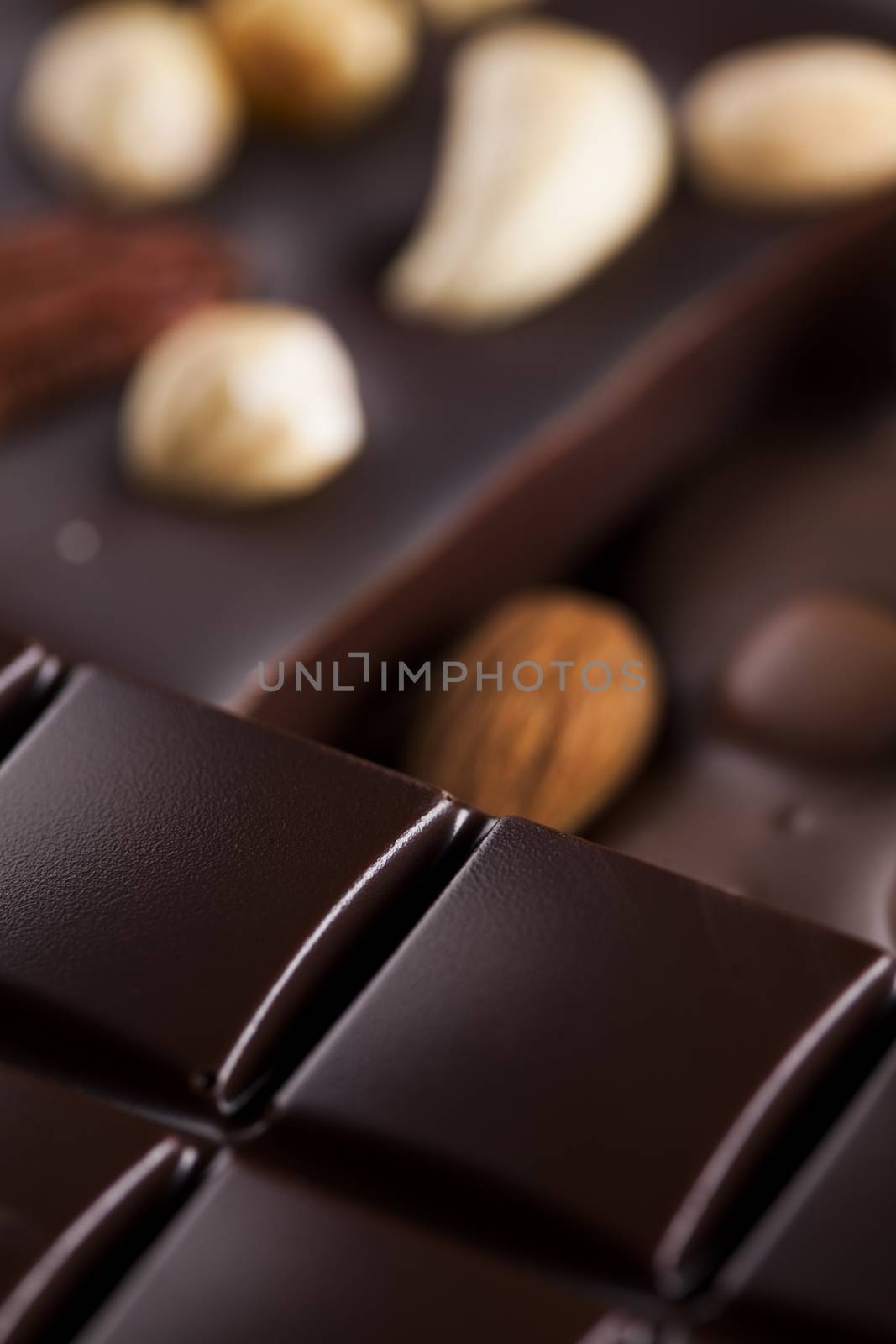 Dark homemade chocolate bars and cocoa pod on wooden  by JanPietruszka