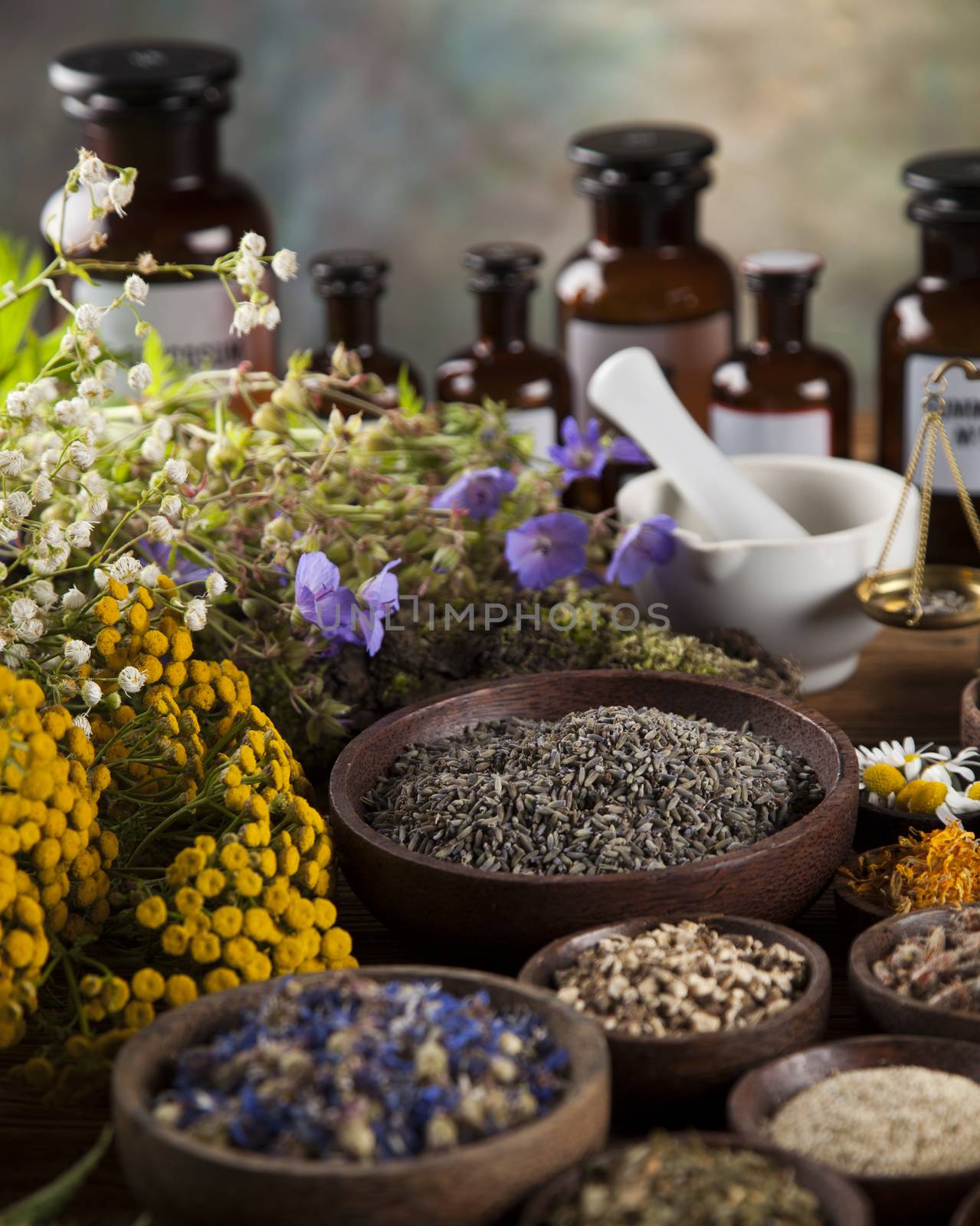 Healing herbs on wooden table, mortar and herbal medicine  by JanPietruszka
