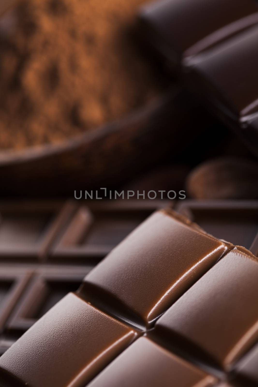 Dark homemade chocolate bars and cocoa pod on wooden  by JanPietruszka