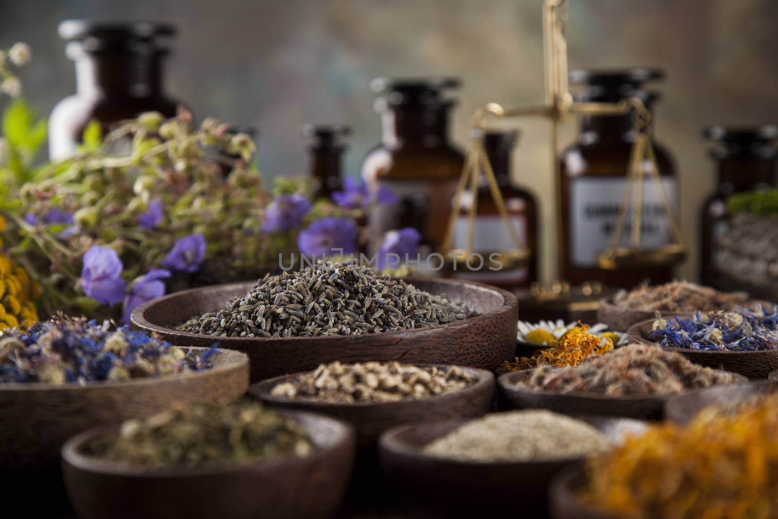 Healing herbs on wooden table, mortar and herbal medicine  by JanPietruszka