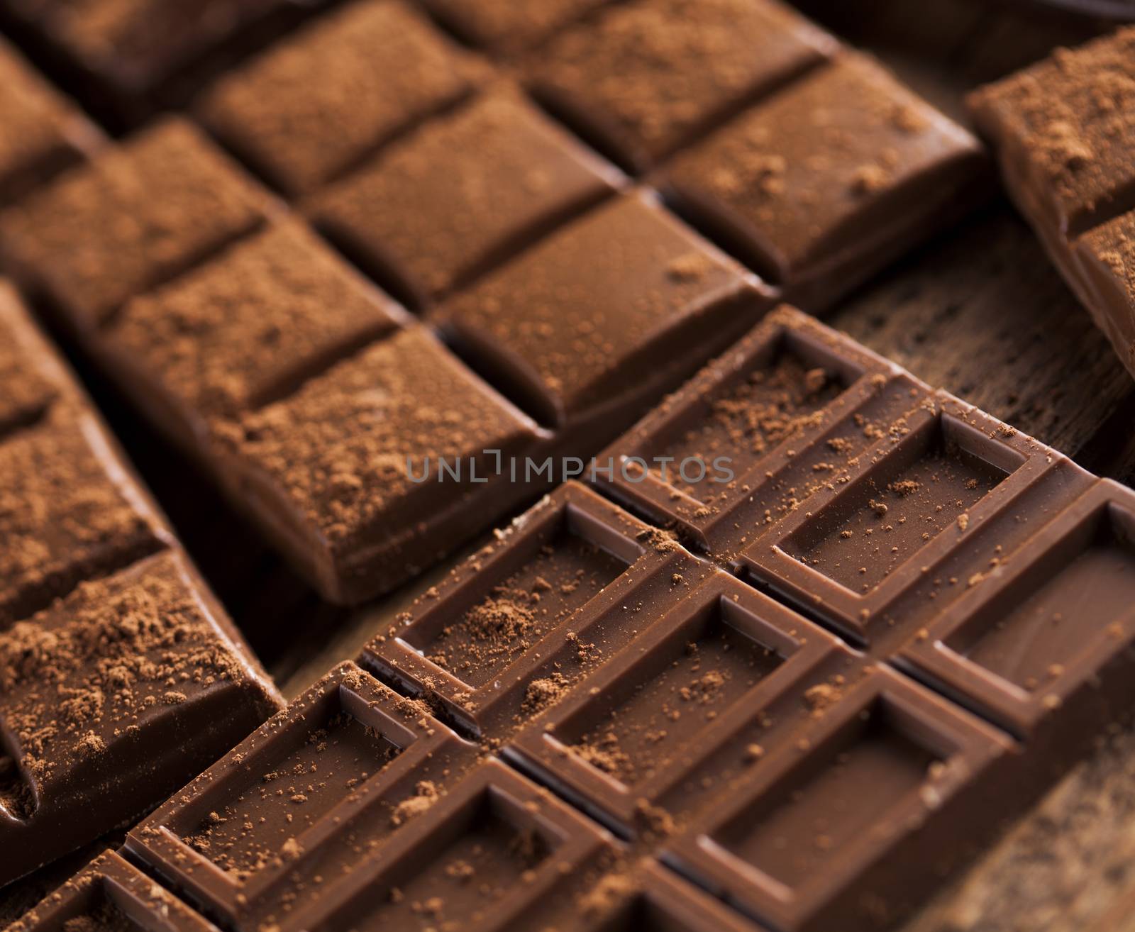 Dark homemade chocolate bars and cocoa pod on wooden  by JanPietruszka