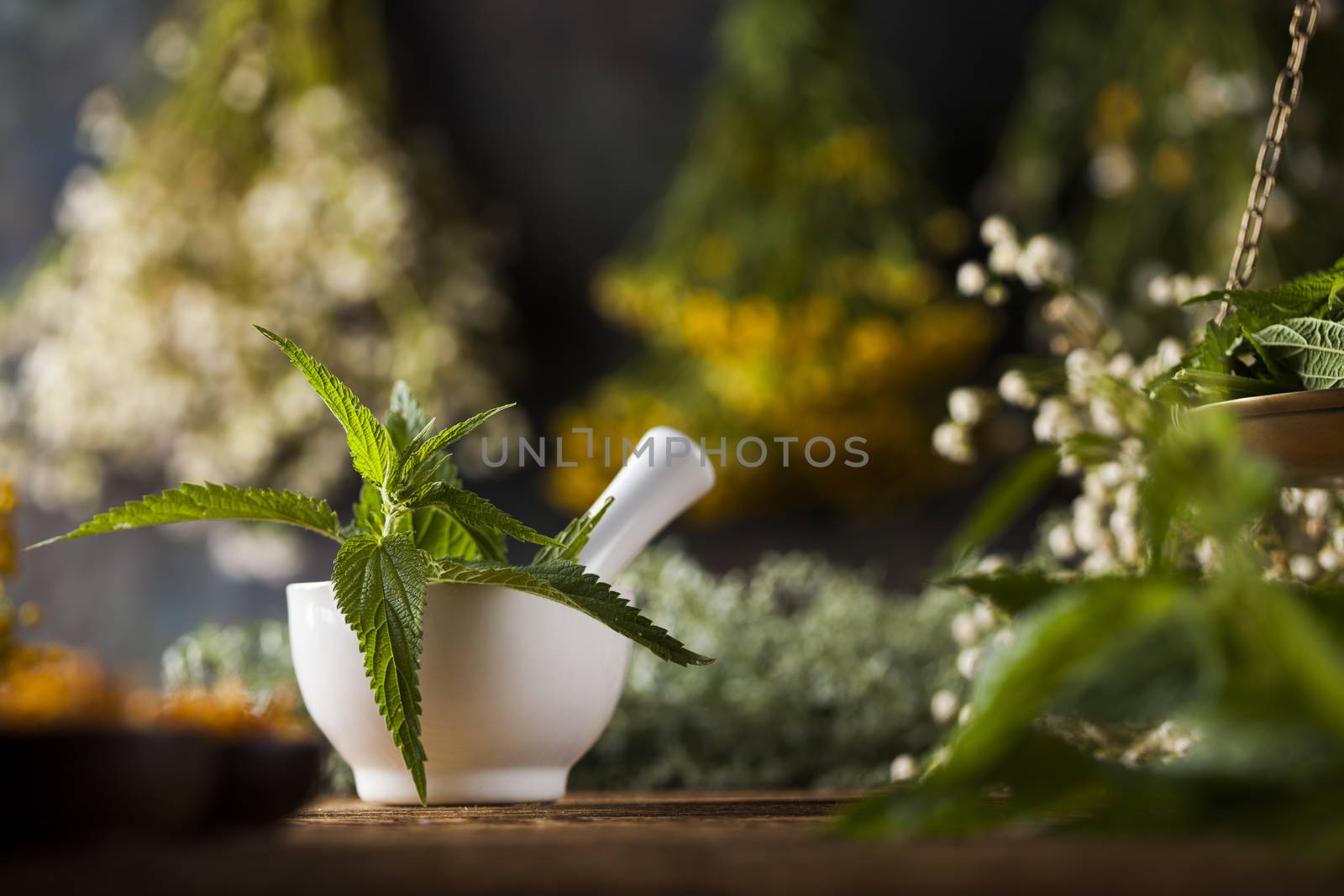 Herbs medicine,Natural remedy and mortar on vintage wooden desk  by JanPietruszka