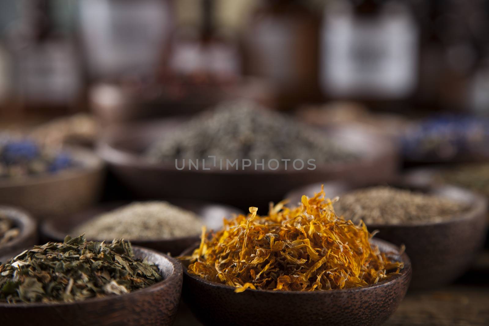 Herbs medicine and vintage wooden desk background by JanPietruszka