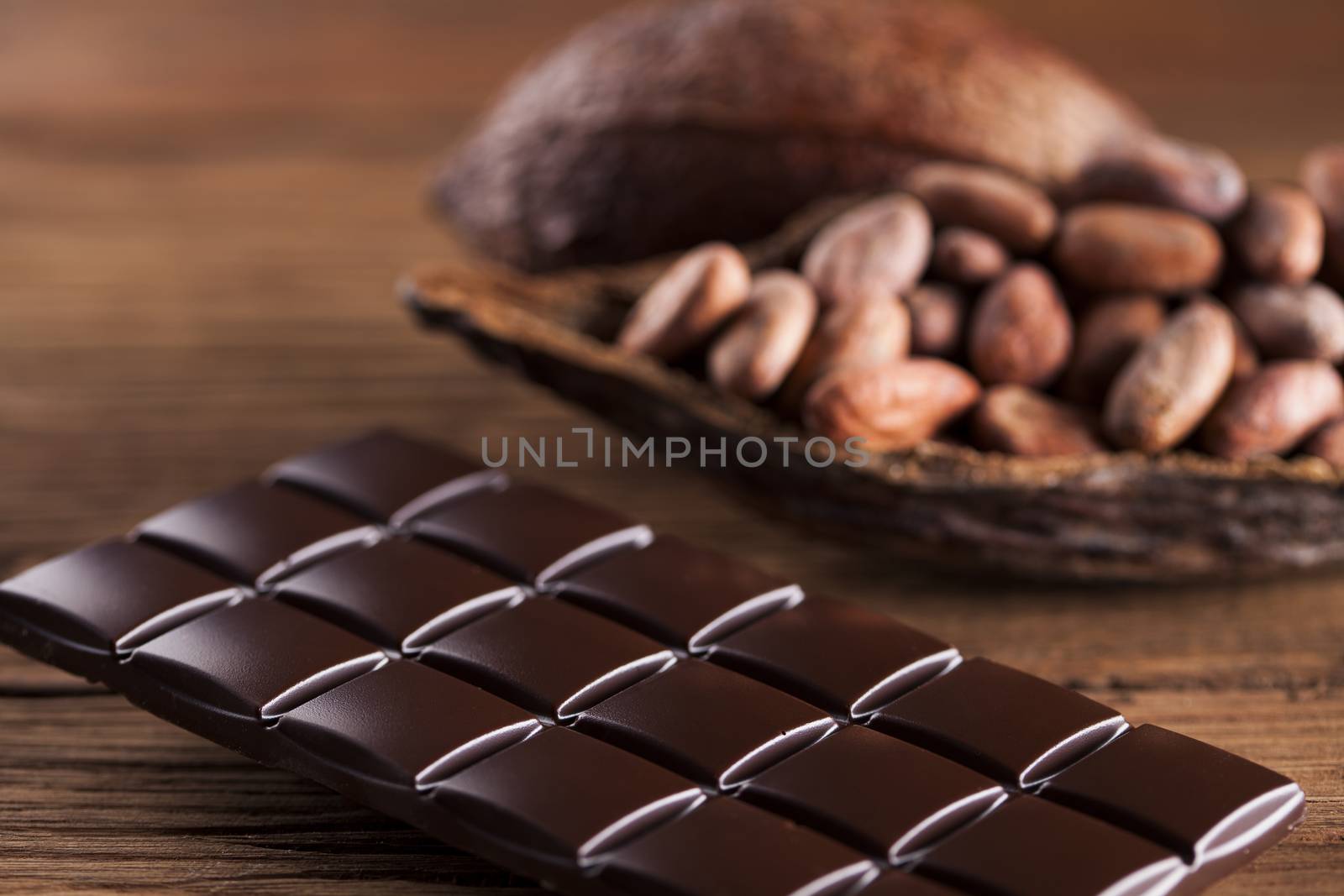 Dark homemade chocolate bars and cocoa pod on wooden  by JanPietruszka